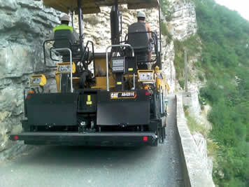 Finisseur Cat sur chenilles caoutchouc en montagne